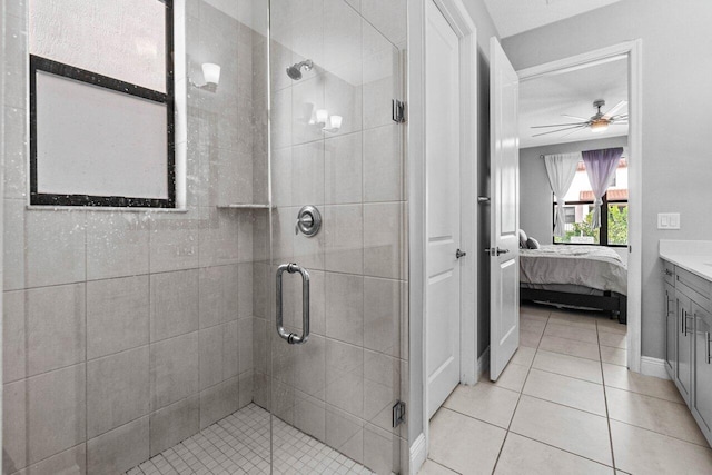 bathroom featuring ceiling fan, tile patterned flooring, vanity, and walk in shower