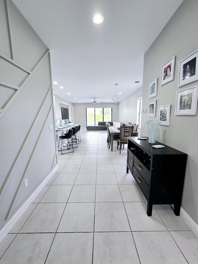 hall featuring light tile patterned floors