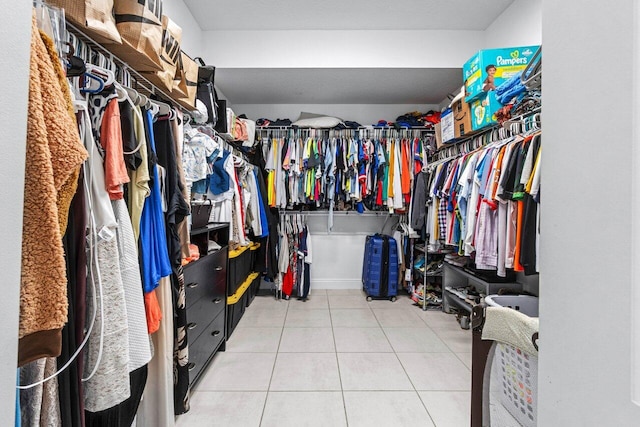 walk in closet with light tile patterned floors