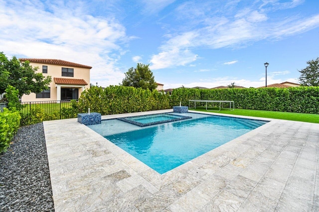 view of pool with an in ground hot tub and a patio