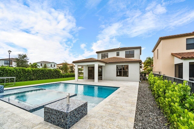 view of pool with an in ground hot tub and a patio