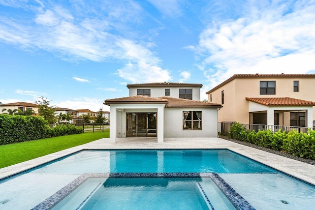 back of property with a pool with hot tub