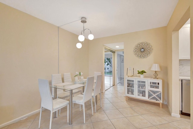 dining room featuring an inviting chandelier and light tile patterned flooring