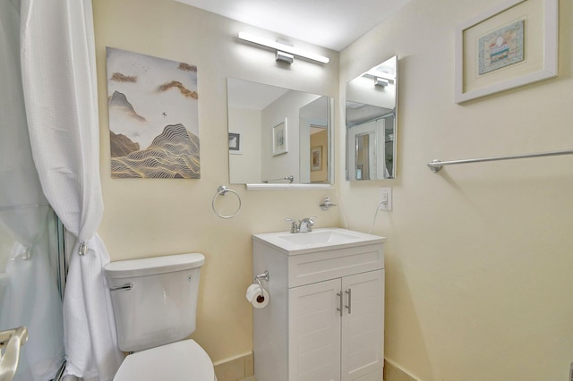 bathroom featuring toilet and vanity