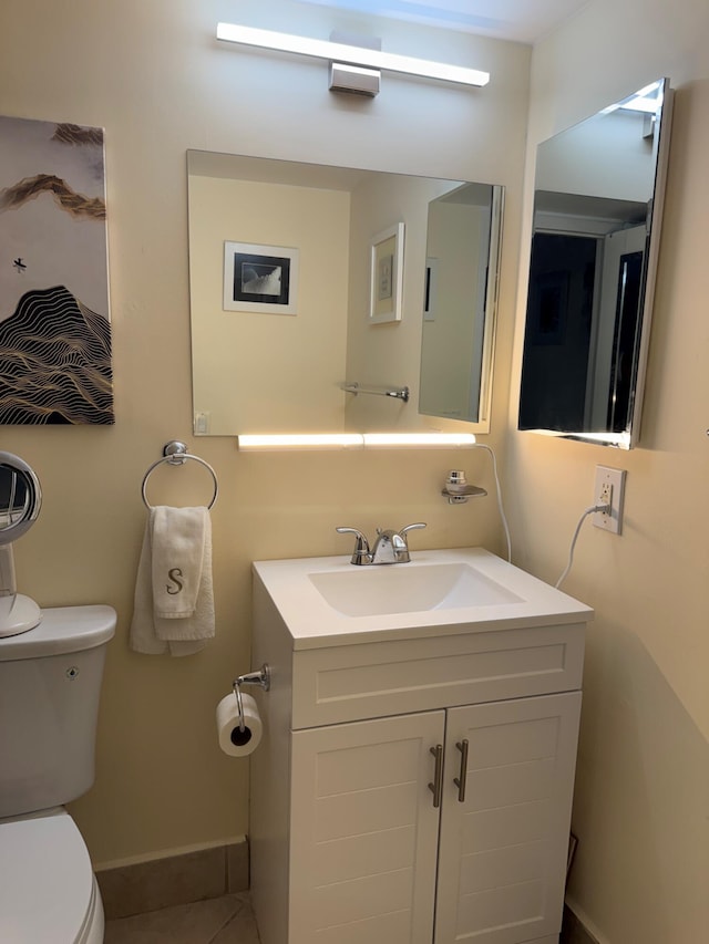 bathroom featuring vanity, toilet, and tile patterned floors