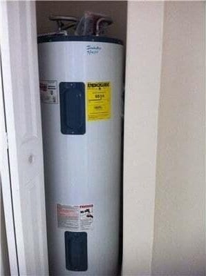 utility room featuring water heater