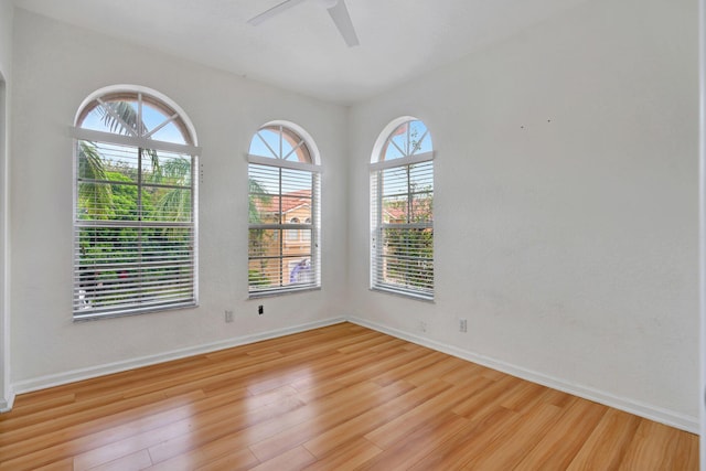 unfurnished room with light wood-type flooring, ceiling fan, and a healthy amount of sunlight