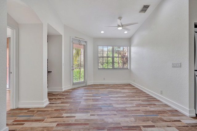 unfurnished room with ceiling fan and light hardwood / wood-style floors