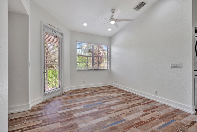 unfurnished room with light hardwood / wood-style flooring, plenty of natural light, and ceiling fan