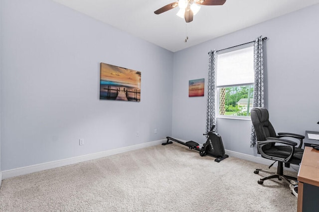 carpeted office featuring ceiling fan