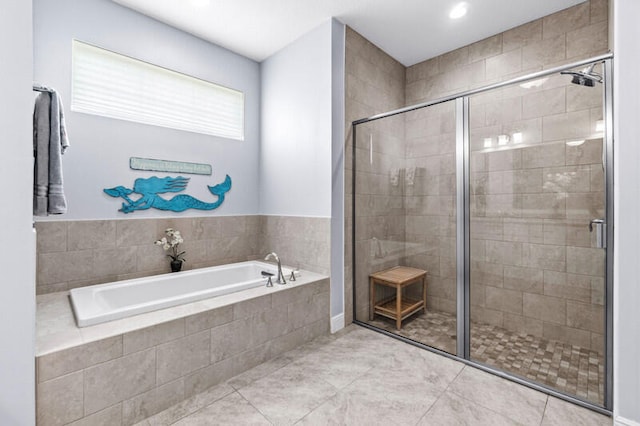 bathroom with tile patterned floors and independent shower and bath