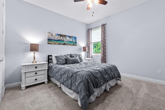 bedroom featuring light carpet and ceiling fan