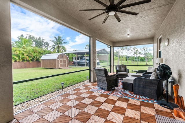 view of patio with an outdoor living space, a storage shed, and ceiling fan