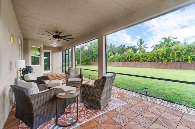 sunroom featuring ceiling fan