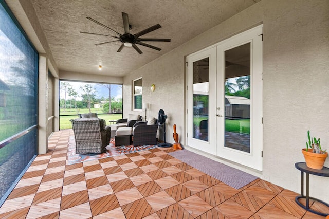 sunroom / solarium with french doors and ceiling fan