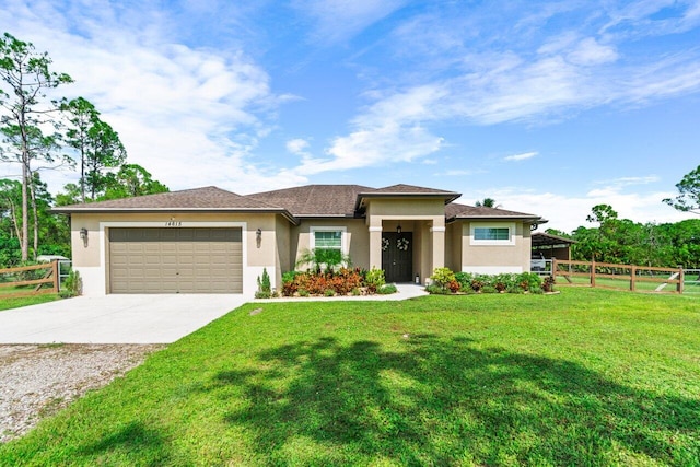 prairie-style house featuring a garage and a front lawn