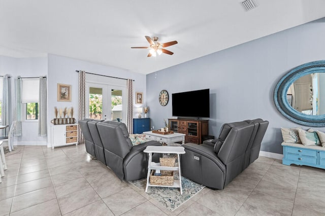 tiled living room with french doors and ceiling fan