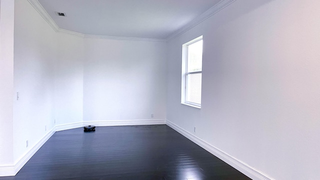 spare room with ornamental molding and dark wood-type flooring