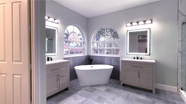 bathroom with vanity, independent shower and bath, tile walls, and tile patterned flooring