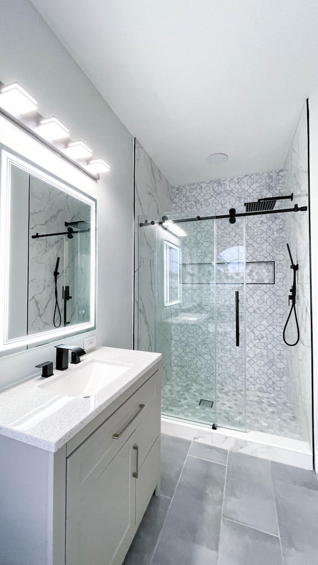 bathroom with vanity, tile patterned floors, and walk in shower