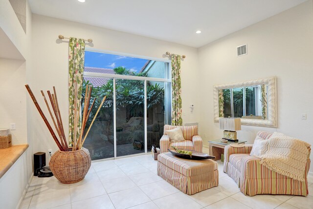 tiled living room with ceiling fan