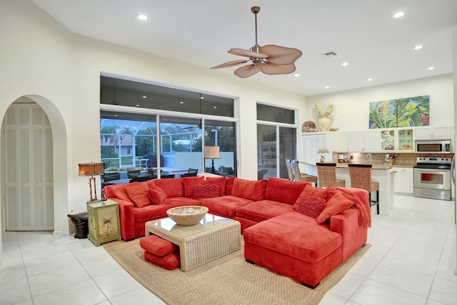 tiled living room with ceiling fan