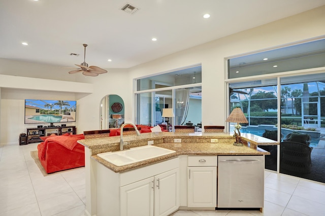 kitchen featuring a kitchen island with sink, sink, dishwasher, and white cabinets