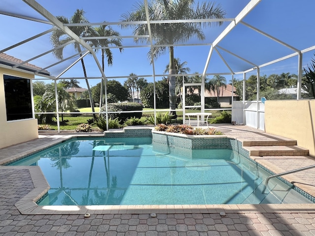 outdoor pool with a patio area and a lanai