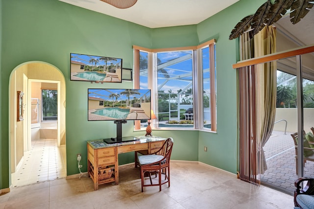 tiled office featuring plenty of natural light and ceiling fan