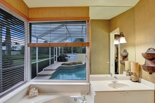 bathroom with a washtub and vanity