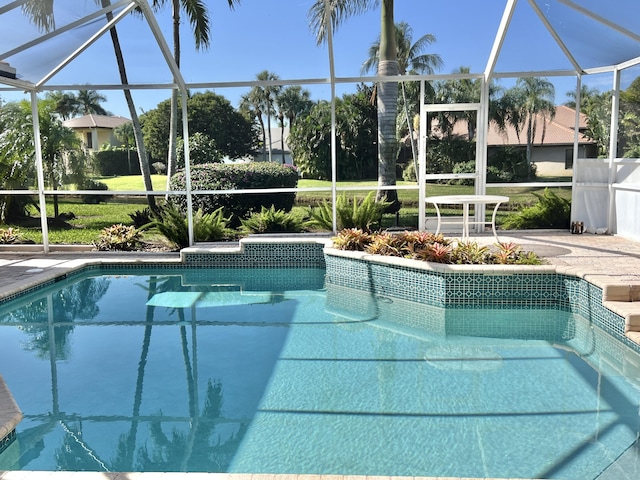 view of swimming pool featuring a patio area and glass enclosure