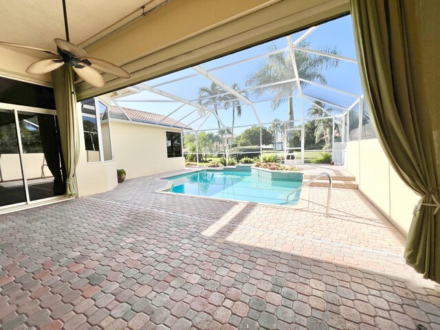 doorway to outside with a healthy amount of sunlight, light tile patterned floors, and ceiling fan