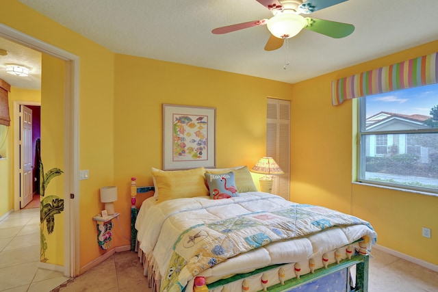 bedroom with light tile patterned floors and ceiling fan