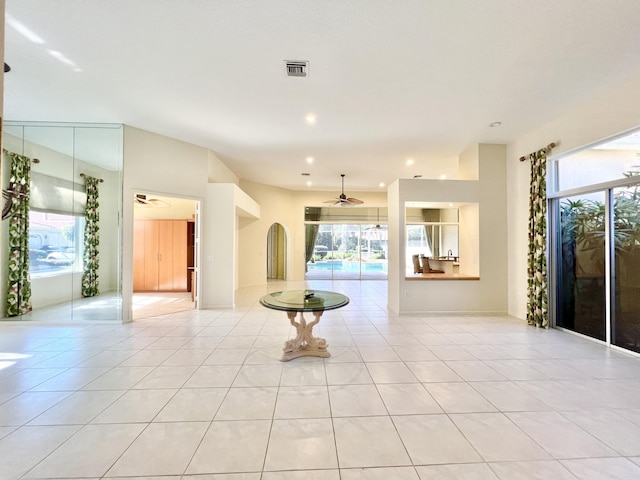 tiled empty room featuring ceiling fan