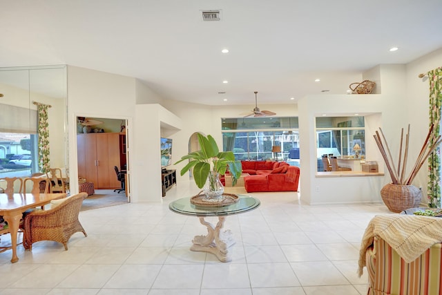 living room featuring plenty of natural light, ceiling fan, and light tile patterned flooring