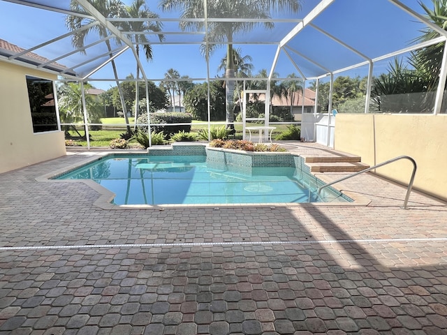 view of swimming pool with a lanai and a patio area