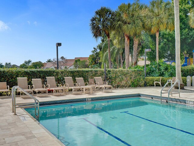 view of swimming pool with a patio area