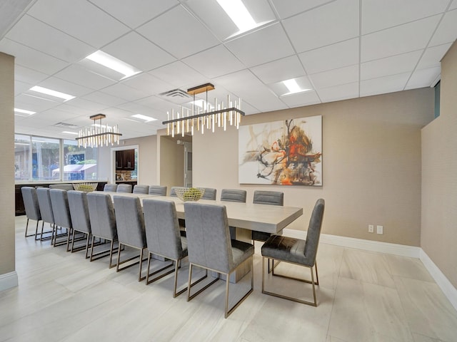 dining space with a paneled ceiling