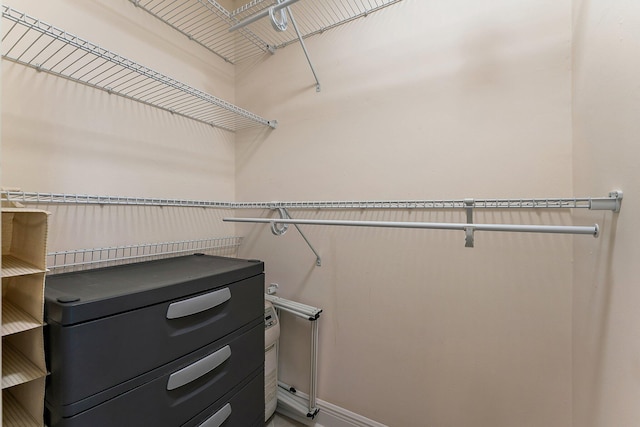 laundry area featuring stacked washer / drying machine