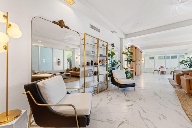 living room with a wealth of natural light and beamed ceiling