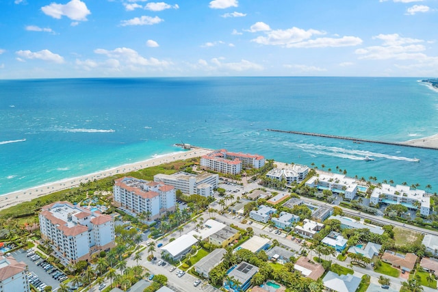 birds eye view of property with a water view and a view of the beach