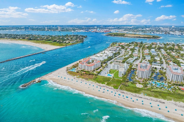 birds eye view of property with a water view and a view of the beach