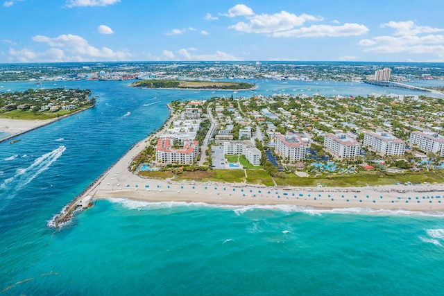 birds eye view of property featuring a water view and a beach view