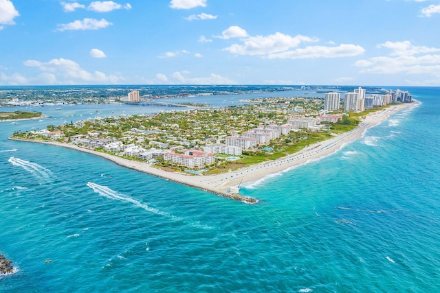 drone / aerial view featuring a water view and a beach view