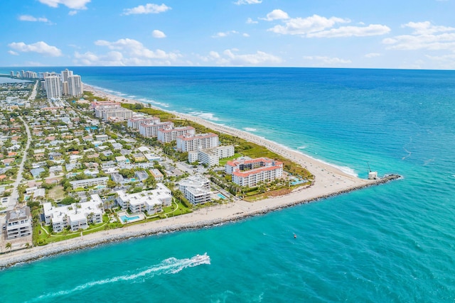 birds eye view of property featuring a water view and a beach view