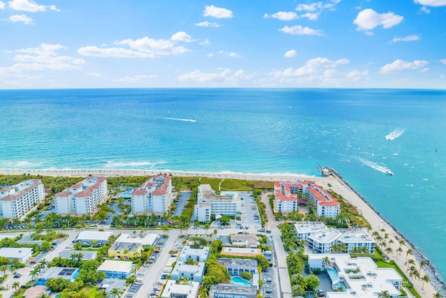 birds eye view of property with a water view and a view of the beach