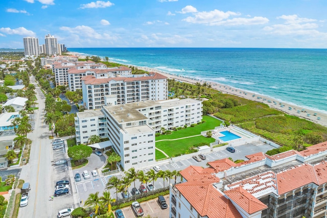 drone / aerial view with a water view and a beach view