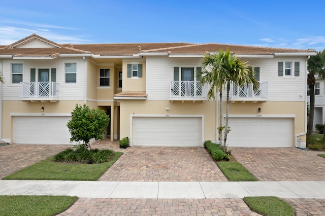 multi unit property featuring a garage and a balcony