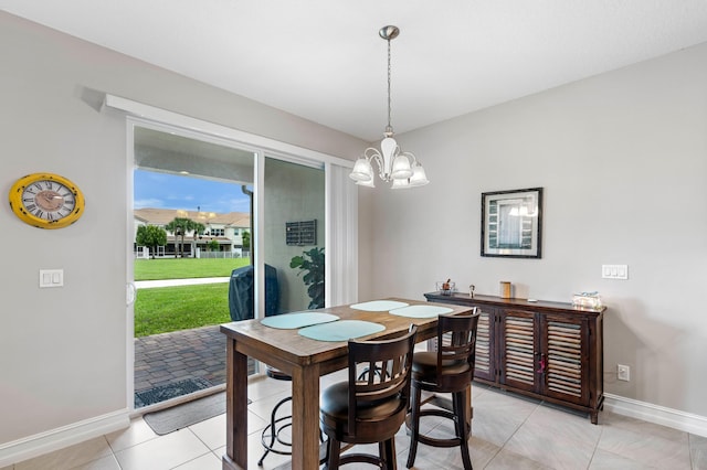 tiled dining area with an inviting chandelier