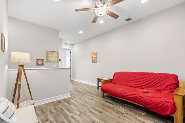 sitting room featuring ceiling fan and wood-type flooring